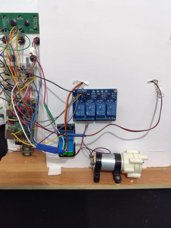 Electronics prototype with relay module, wiring, control board, and compact actuators for the automated coffee preparation system
